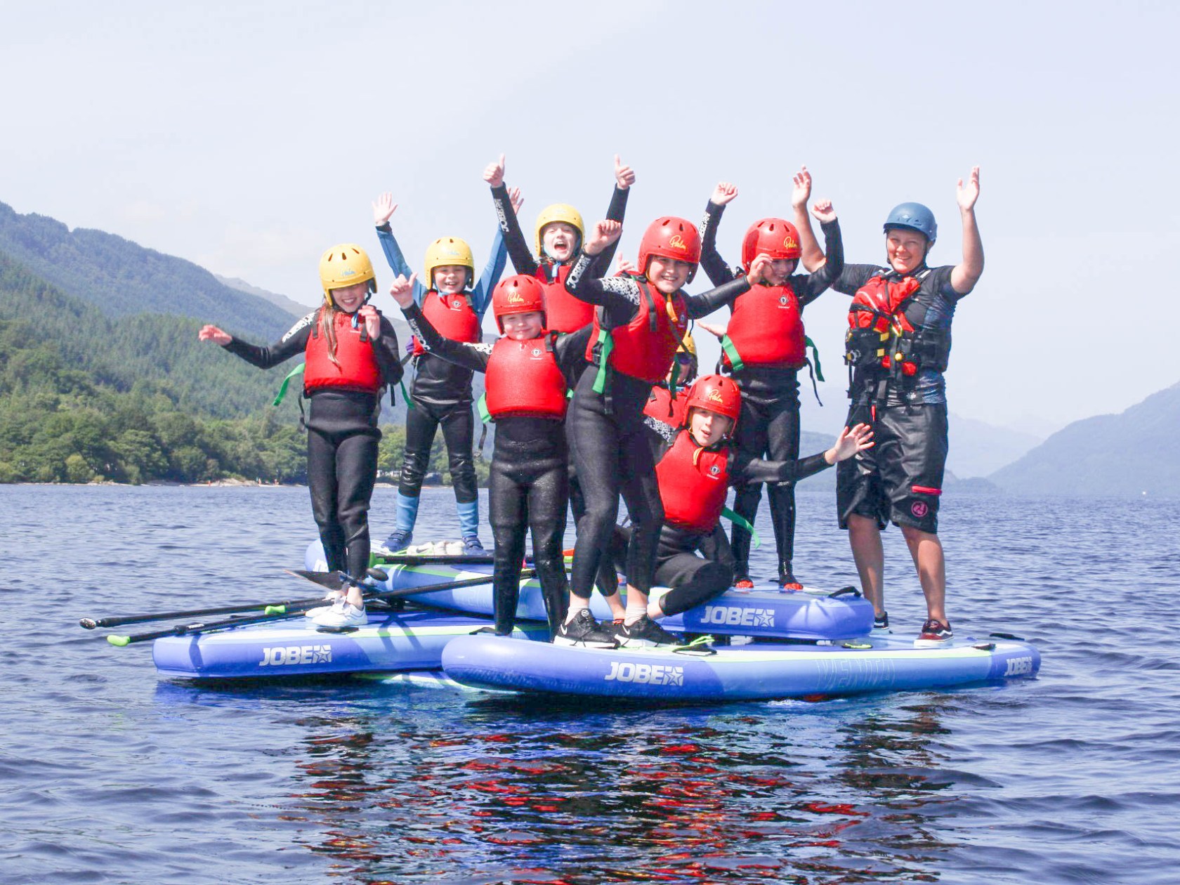 a group of people riding skis on a body of water