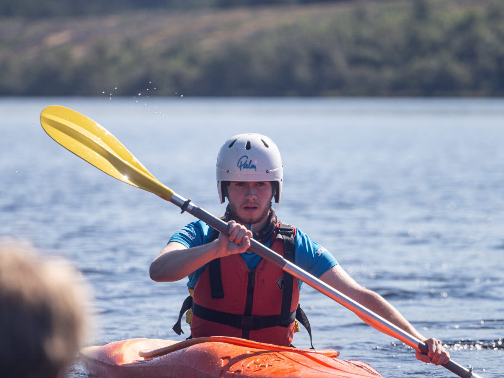 a man rowing a boat in a body of water