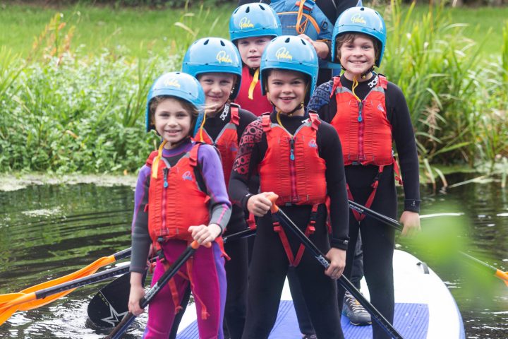 a group of people riding on the back of a boat