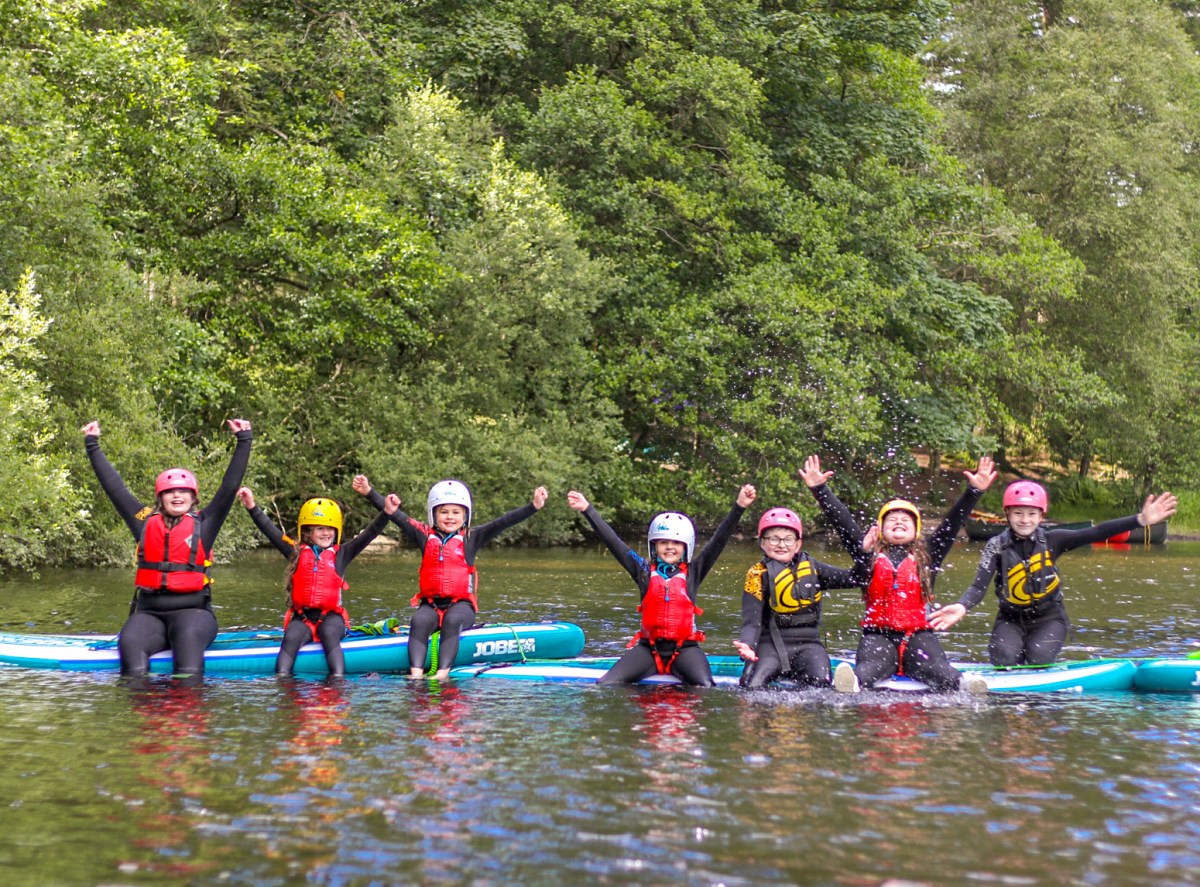 a group of people rowing a boat in the water