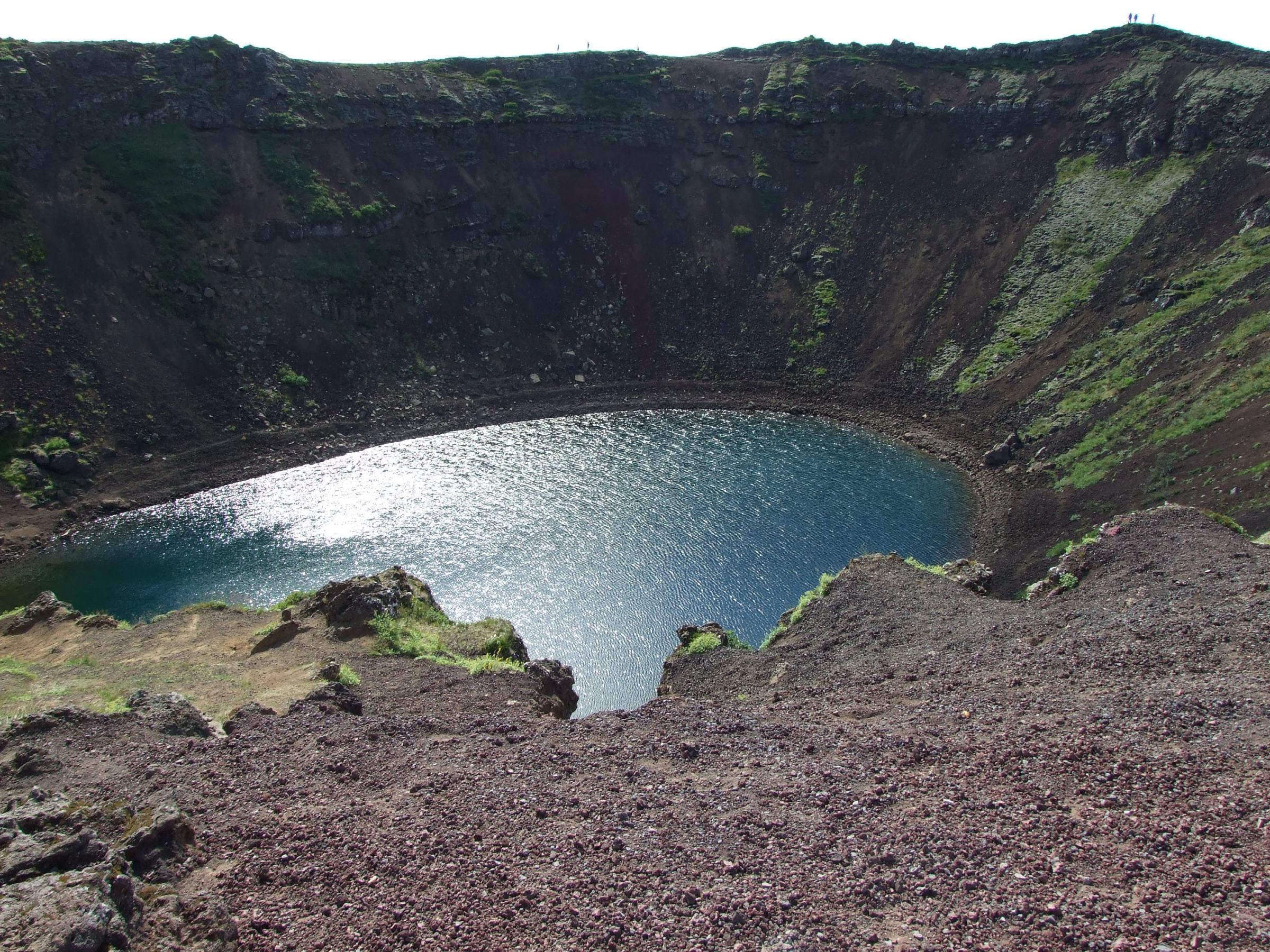a body of water with a mountain in the background